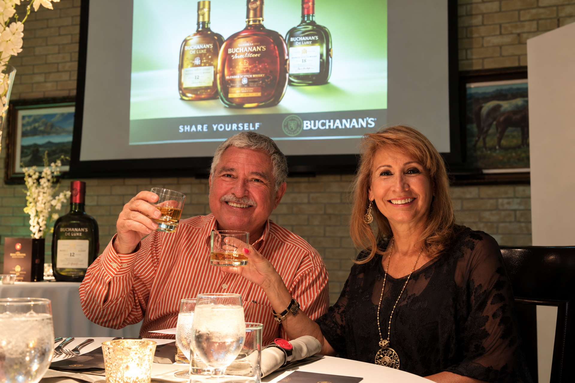 Guests raising a toast at a Buchanan’s VIP hospitality dinner