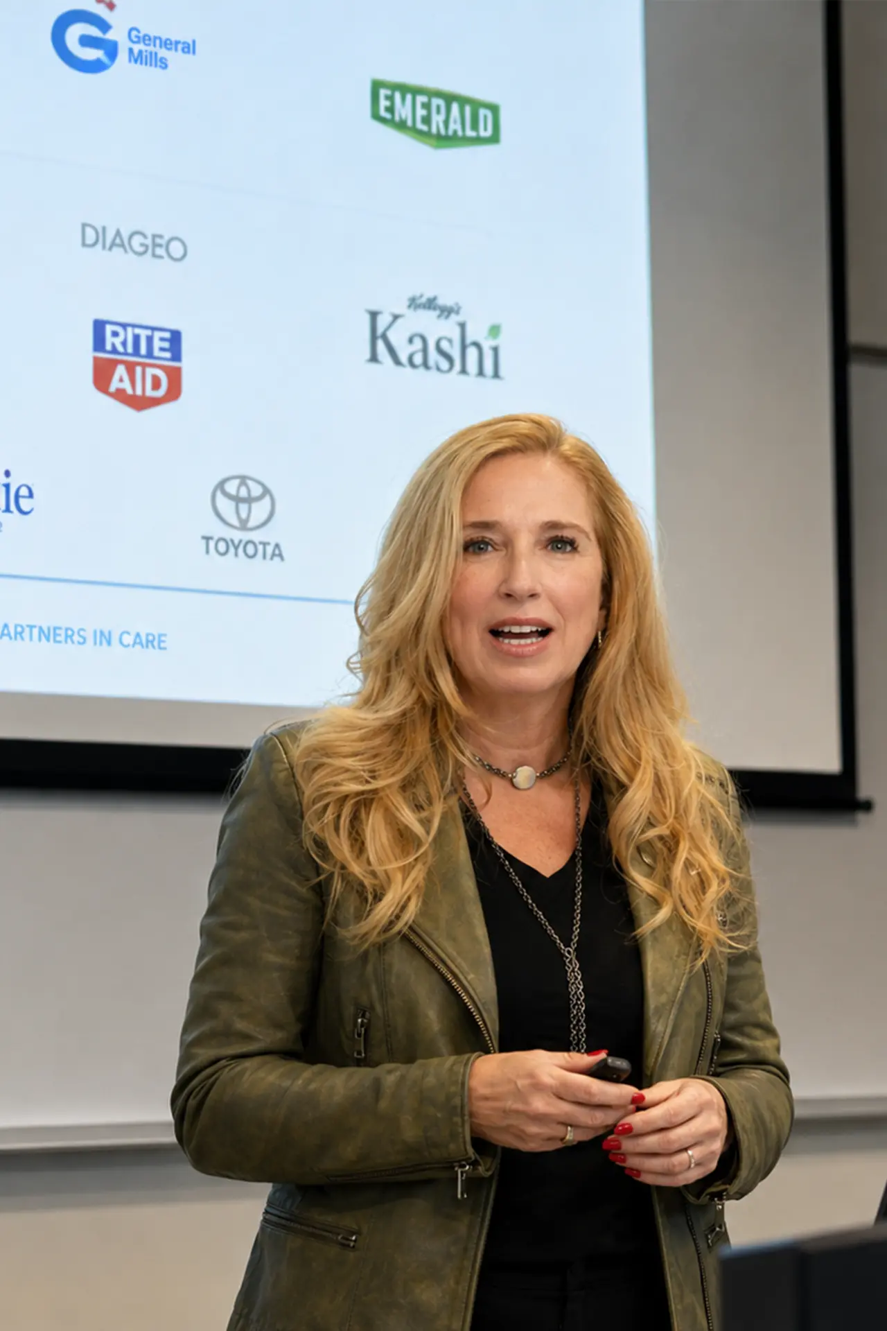 Sheila Rondeau leading a customized marketing presentation in front of a slide with partner brand logos